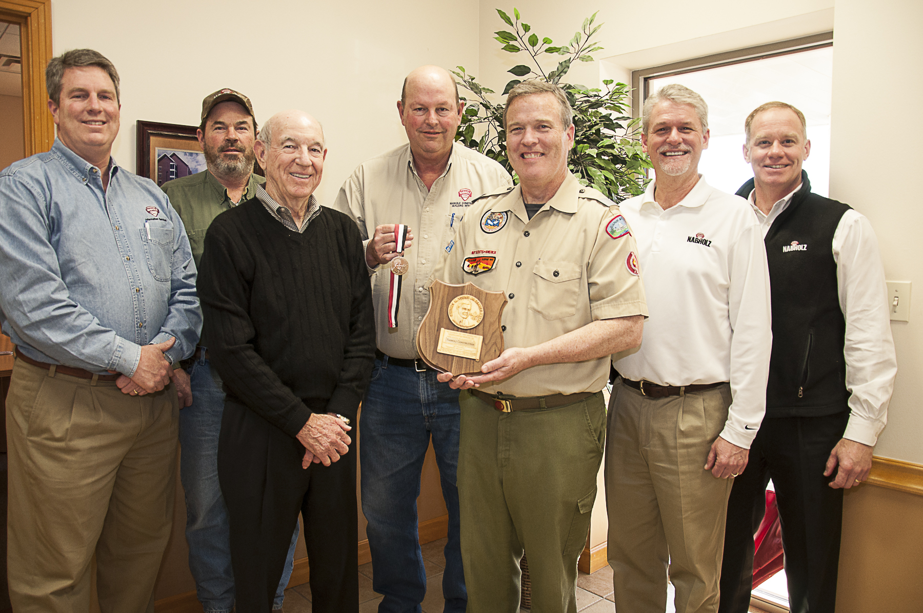 Members of the Nabholz Board accept the Whitney M. Young Jr. Service Award from Scout Executive John Carman