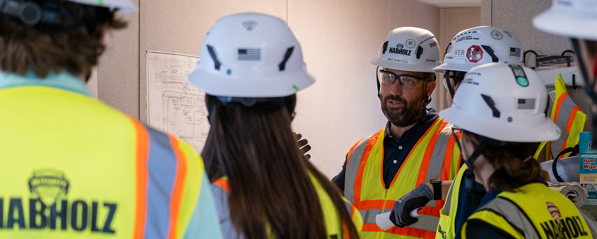 CEO Jake Nabholz speaks to interns in PPE about the new home office